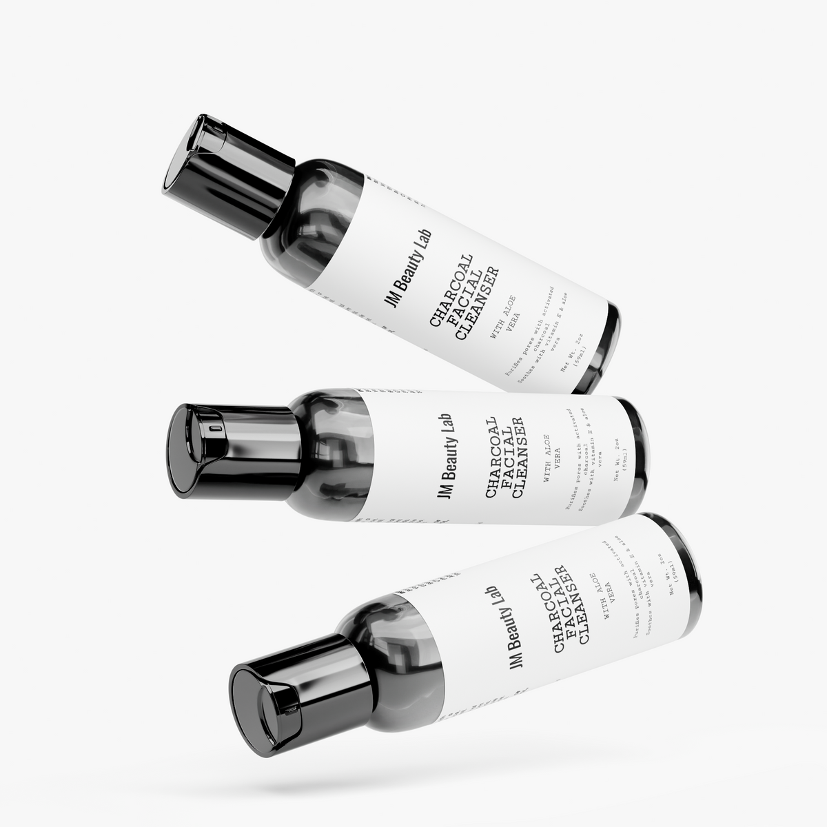 Charcoal facial cleanser bottles angled, black pump tops, JM Beauty Lab