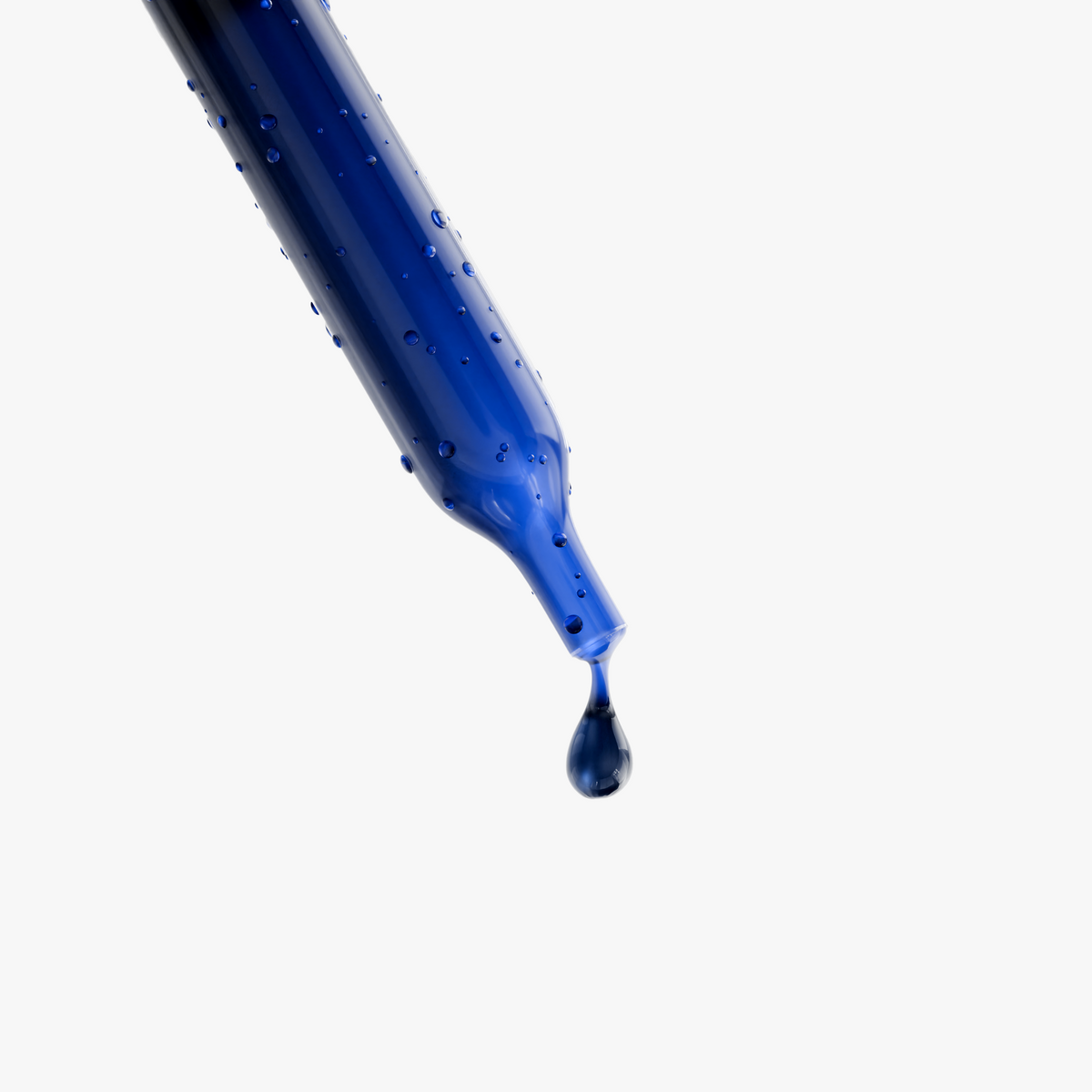 Single blue serum drop from pipette tip