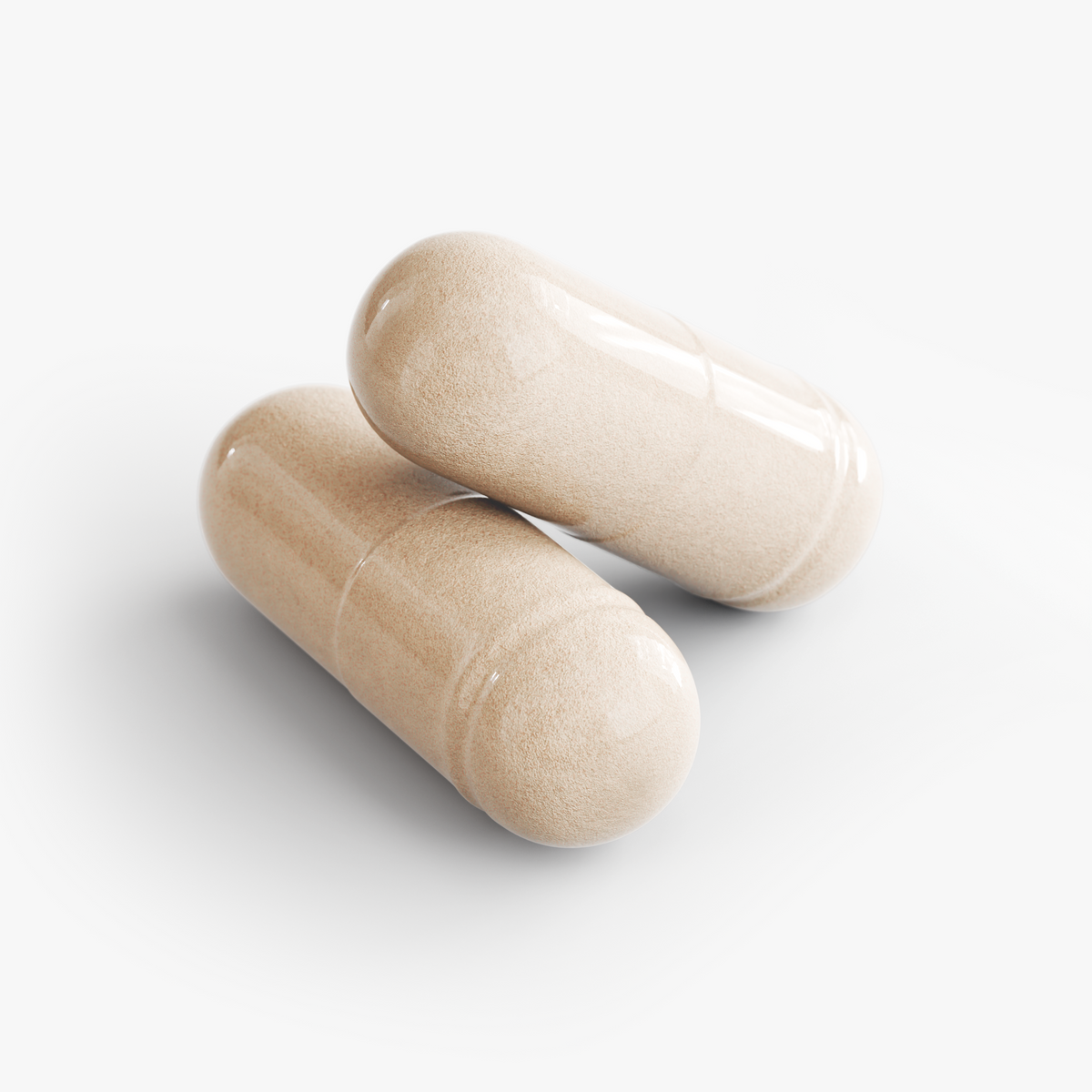 Beige supplement capsules lying on their sides