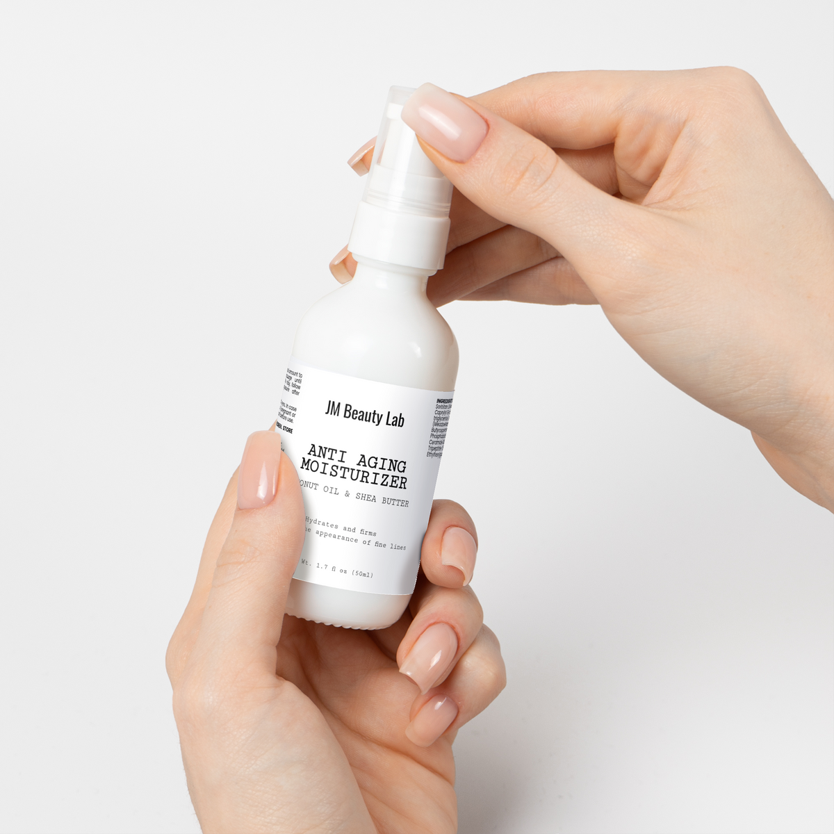 Moisturizer bottle dispensing from pump onto fingertips