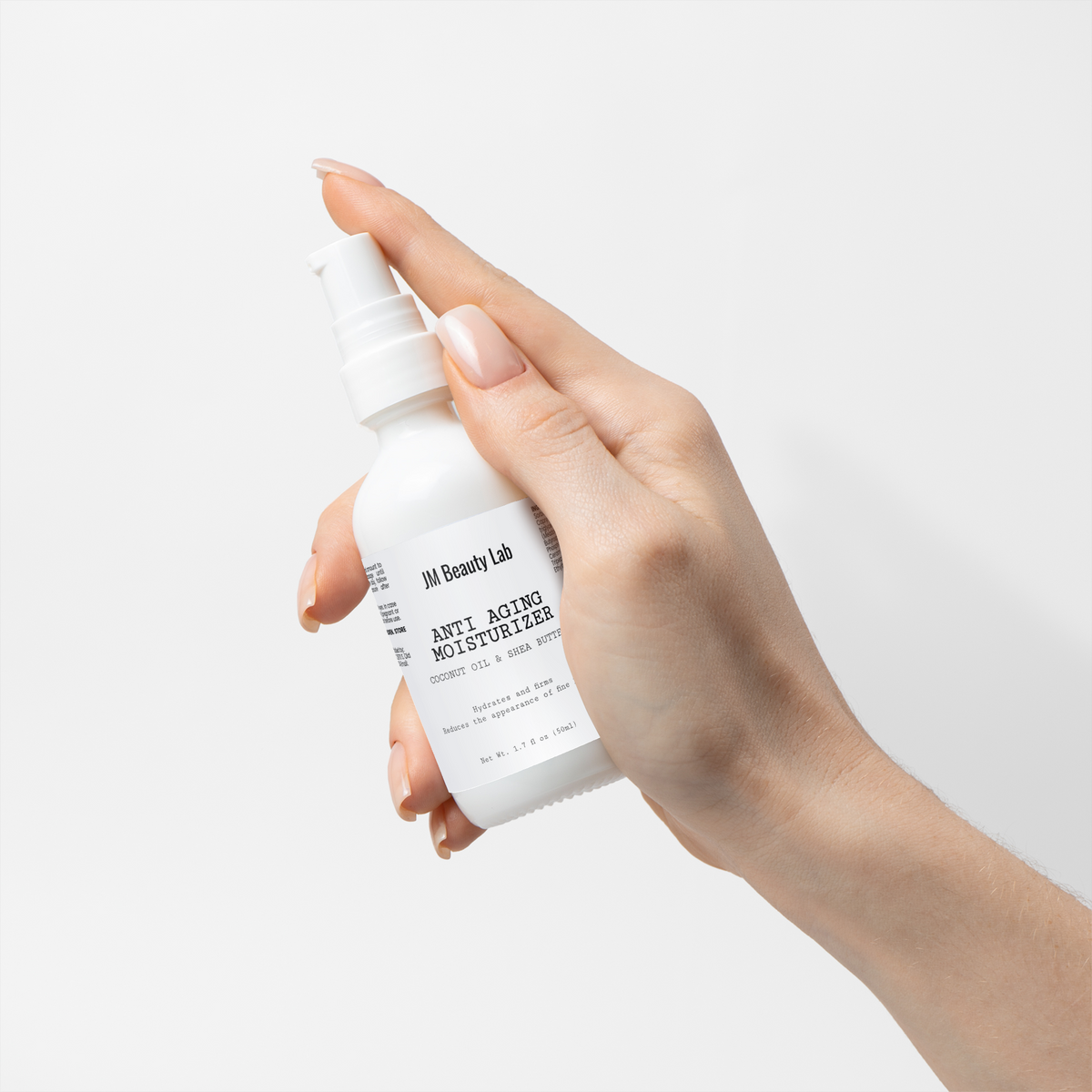 Moisturizer bottle with pump tilted toward open palm