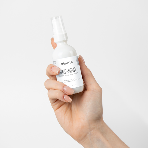 Moisturizer bottle held in hand with white pump top